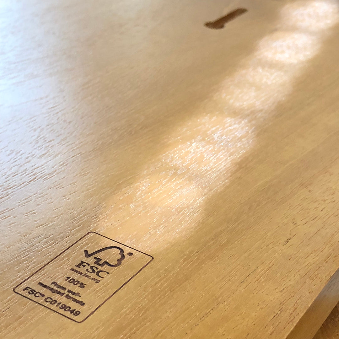 Close-up of the back of an FSC-certified mahogany plaque engrave with the FSC logo and Rivanna's unique license number, highlighting certified sourcing.