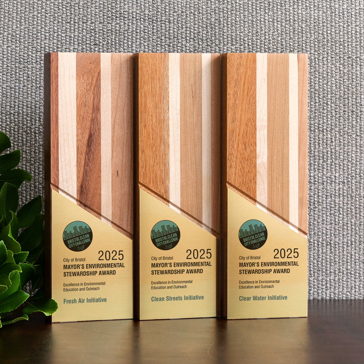 Eco awards handcrafted from mixed scrap woods with engraved gold plates