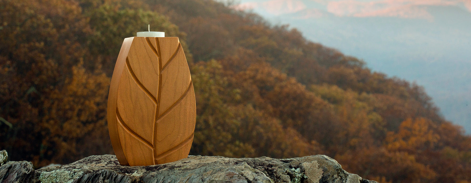 Eco-friendly FSC cherry candle holder with carved leaf design, suitable for use as a sustainable recognition award.
