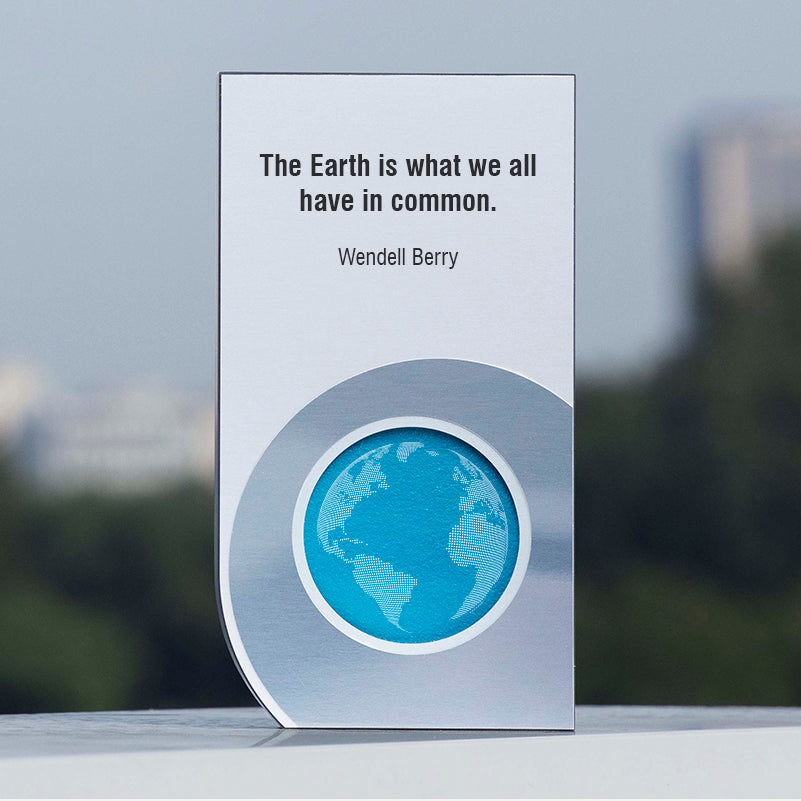 Eco-themed award featuring a globe illustration and a Wendell Berry quote: “The Earth is what we all have in common.”