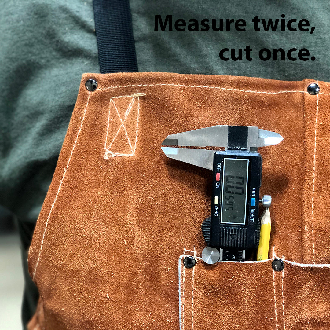 Close-up of a leather apron with digital caliper and pencil, reinforcing Rivanna’s precision and craftsmanship.