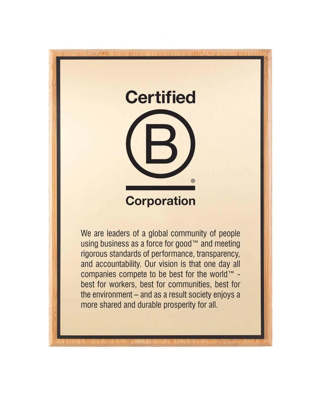 Certified B Corporation bamboo plaque with full engraved mission and vision text on a gold aluminum plate.