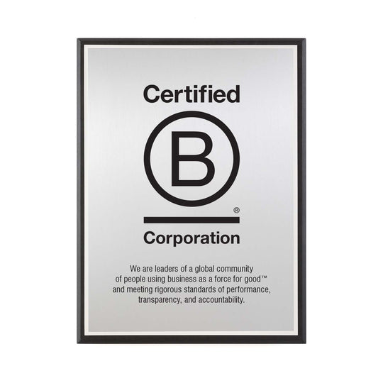 B Corporation silver plaque with logo and engraved mission statement, framed in recycled black Richlite.