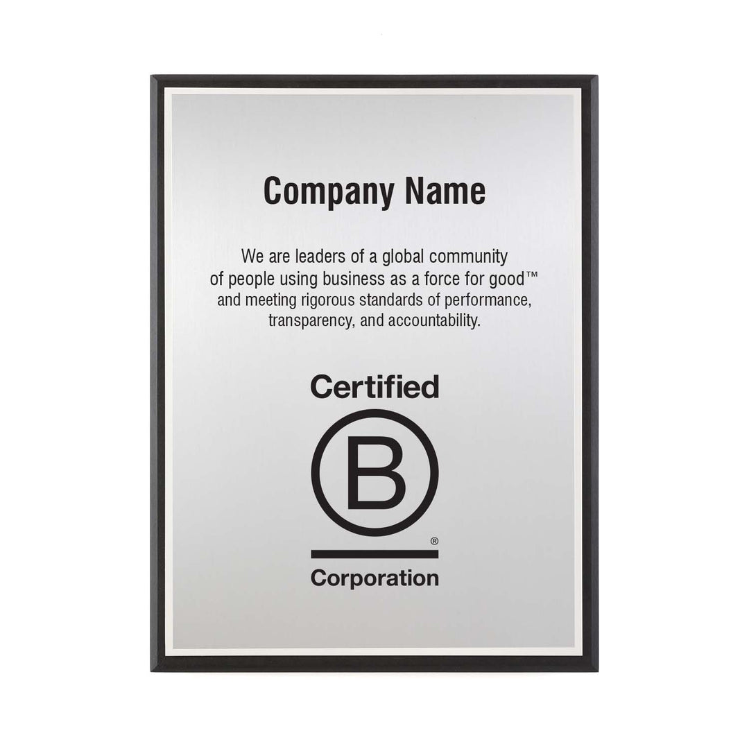 Customizable silver B Corporation plaque with company name, mission statement, and logo on recycled black backer.